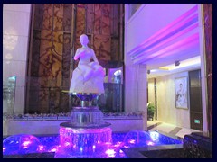 The lobby of Panglin Hotel has sculptures, fountains, marble floors and panels and glass enclosed elevators.